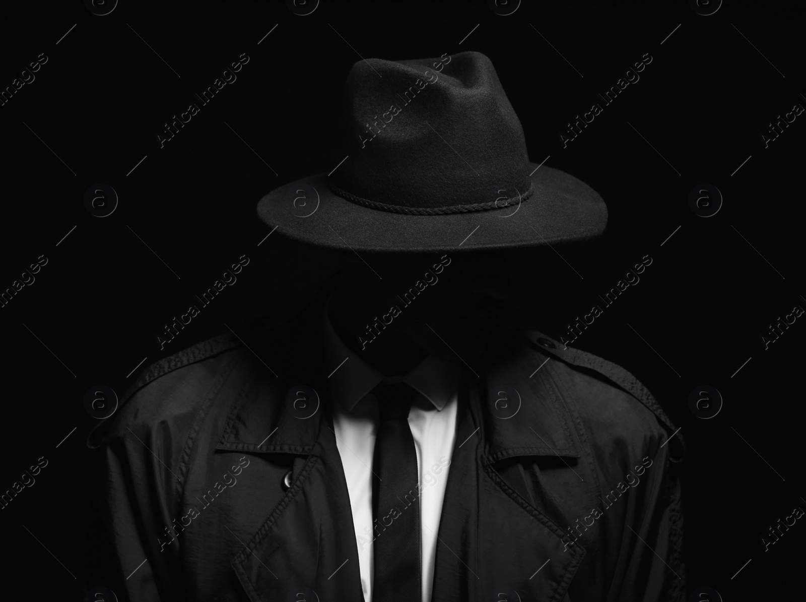 Photo of Old fashioned detective in hat on dark background