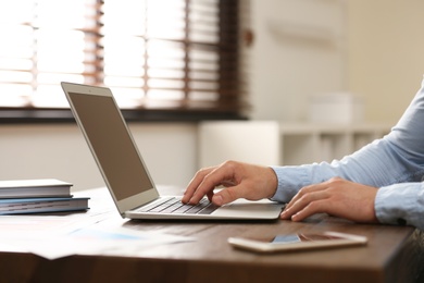 Business trainer working at table in office, closeup