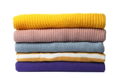 Photo of Stack of folded knitted sweaters on white background