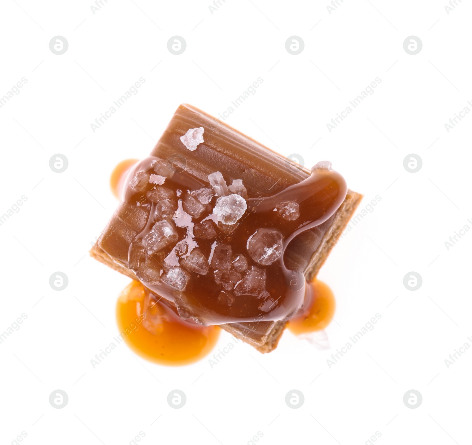 Photo of Delicious salted caramel with sauce on white background, top view