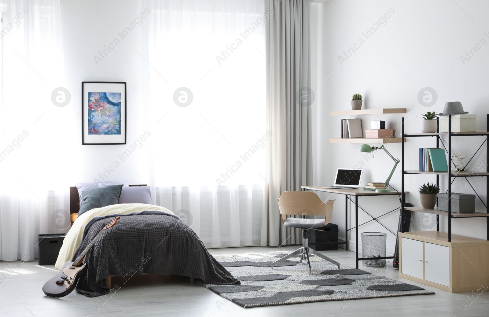 Photo of Modern teenager's room interior with workplace and bed