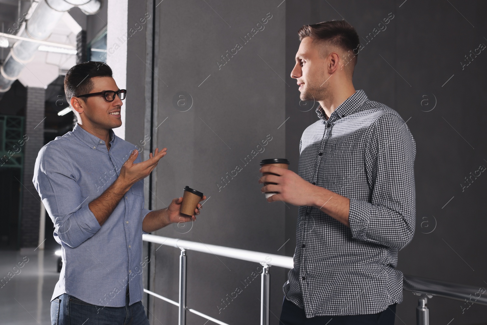 Photo of Coworkers talking during coffee break in office