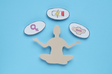 Photo of Woman's health. Female paper figure and different symbols on light blue background, flat lay