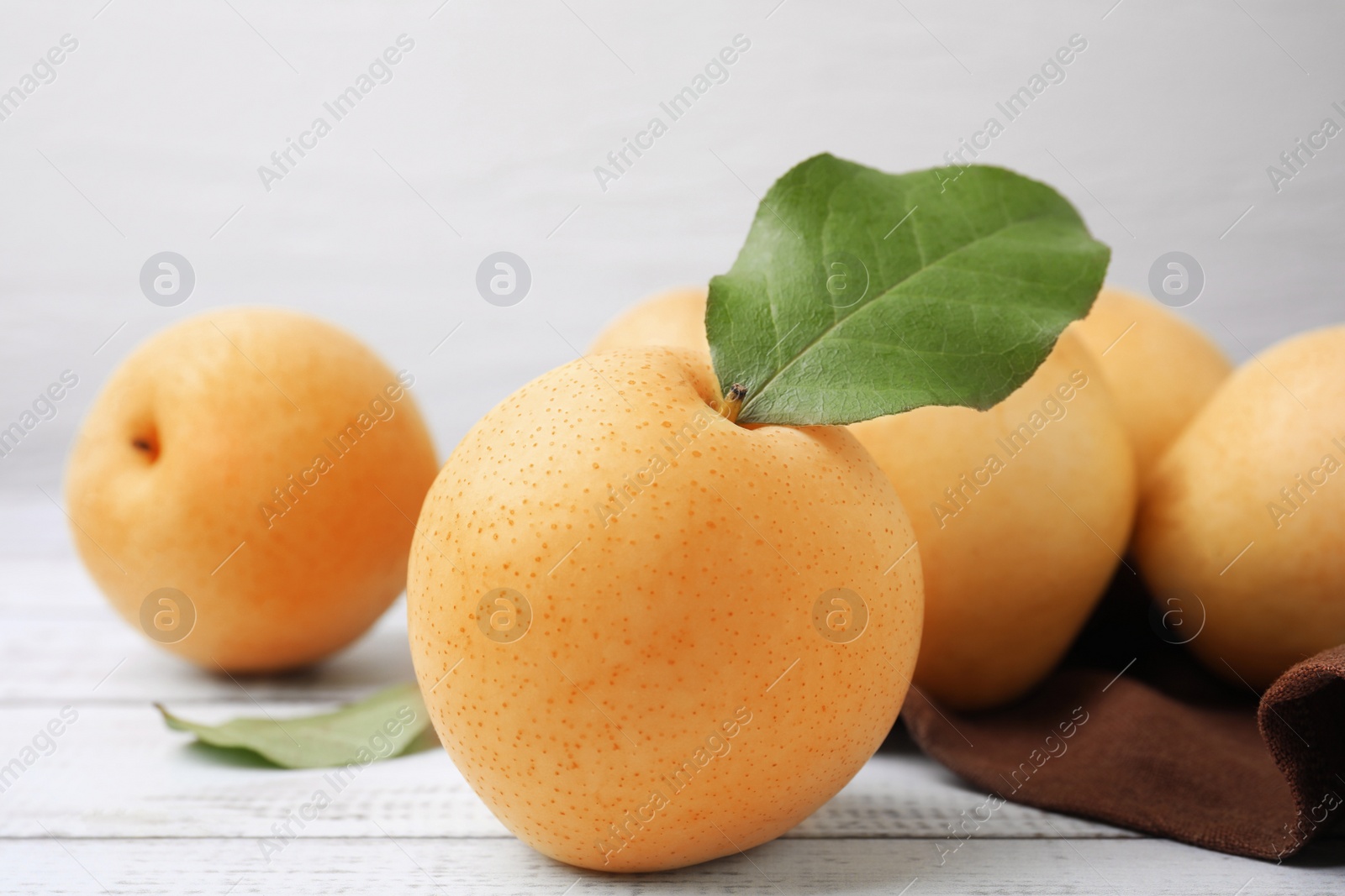 Photo of Delicious apple pears on white wooden table
