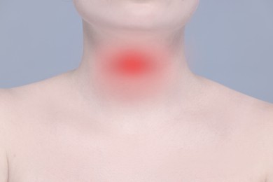 Image of Endocrine system. Woman suffering from pain in thyroid gland on grey background, closeup