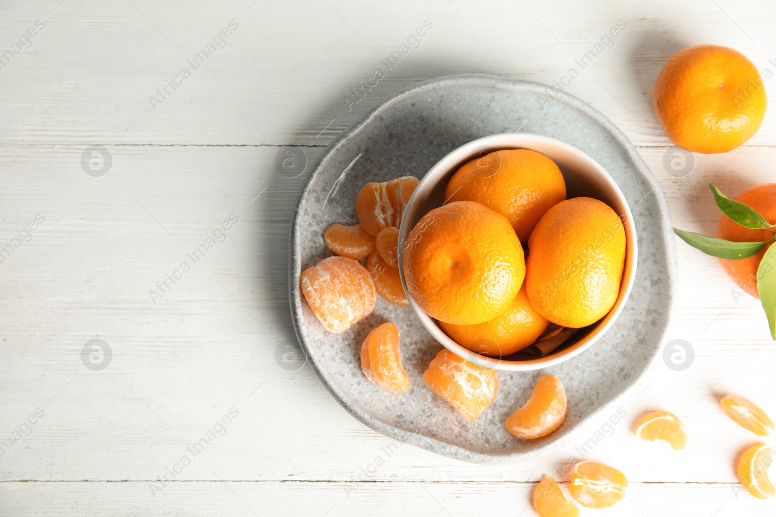 Photo of Flat lay composition with ripe tangerines on white wooden background. Space for text