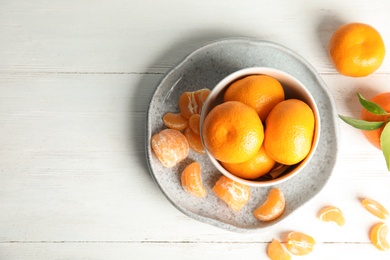 Photo of Flat lay composition with ripe tangerines on white wooden background. Space for text