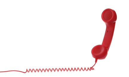 Red corded telephone handset on white background. Hotline concept