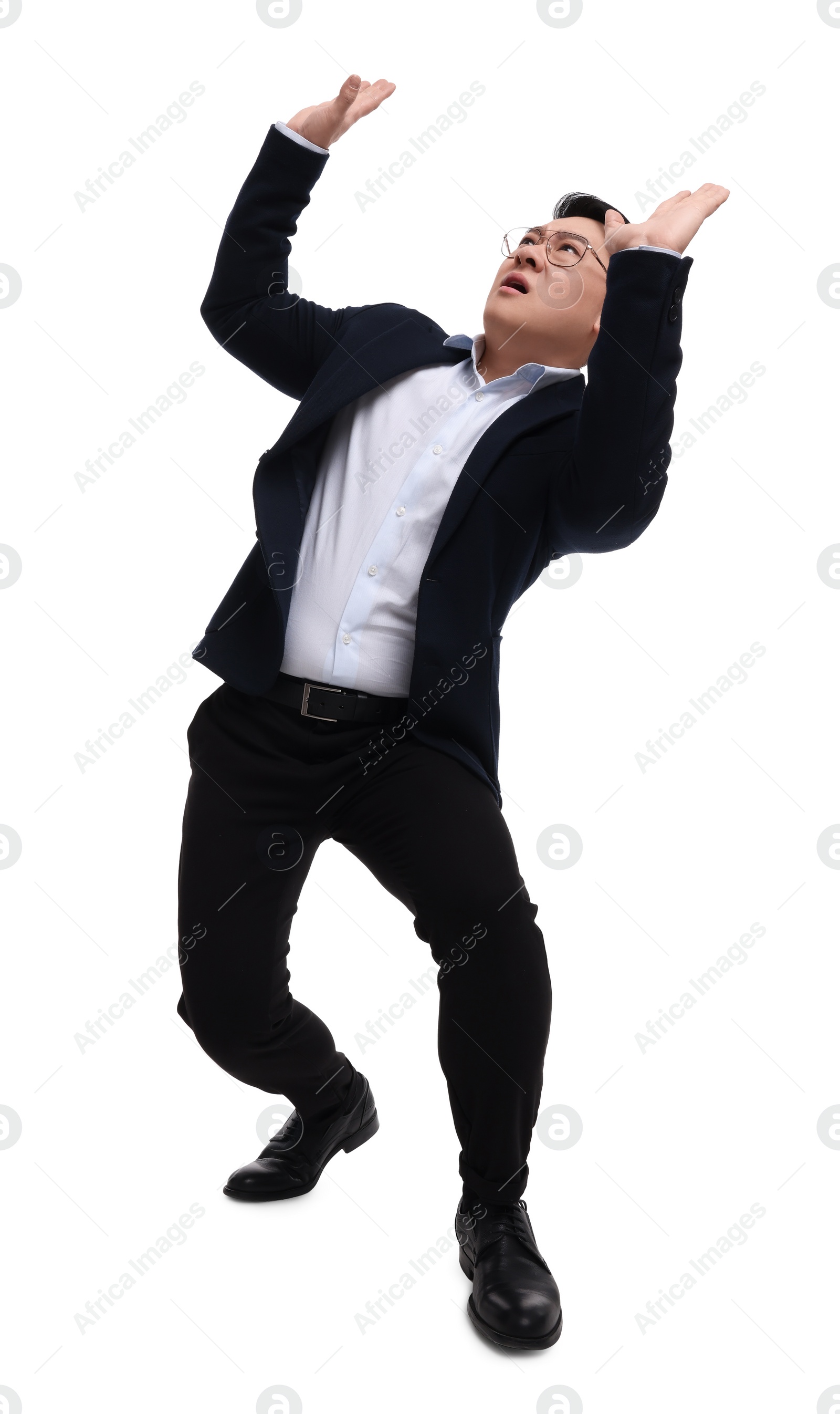 Photo of Businessman in suit posing on white background, low angle view