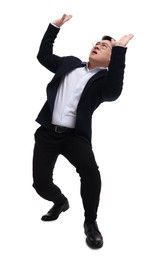 Businessman in suit posing on white background, low angle view