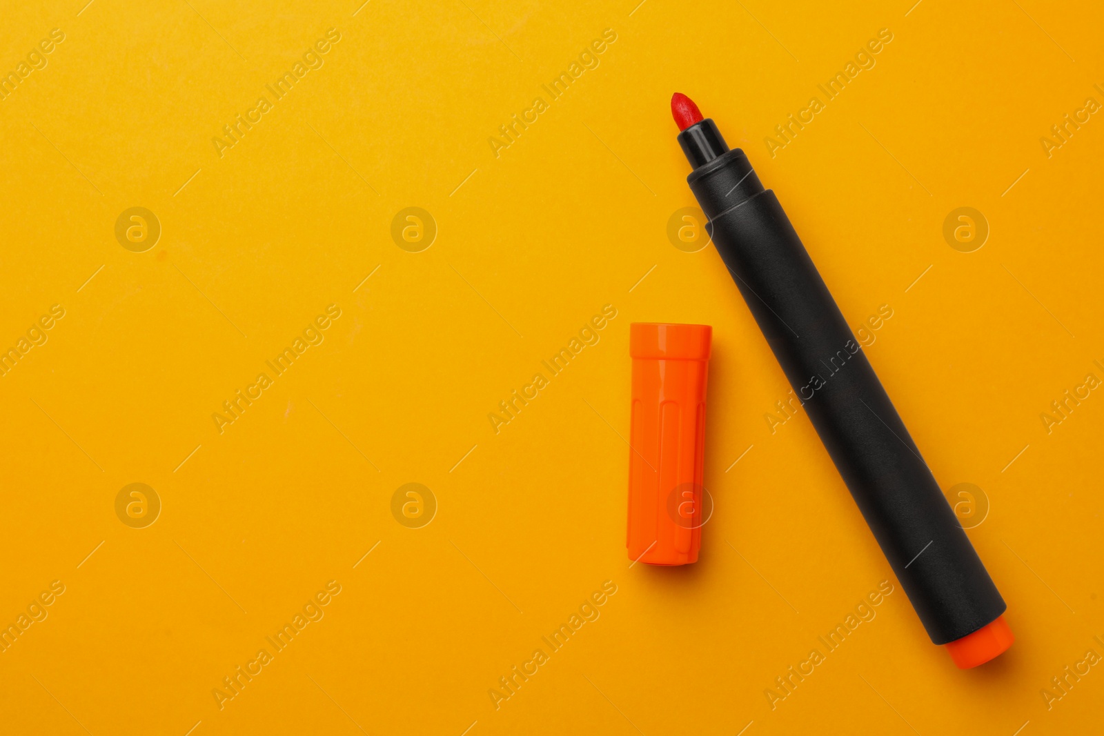 Photo of Bright marker on orange background, flat lay. Space for text