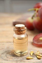 Photo of Natural grape seed oil on wooden table. Organic cosmetic