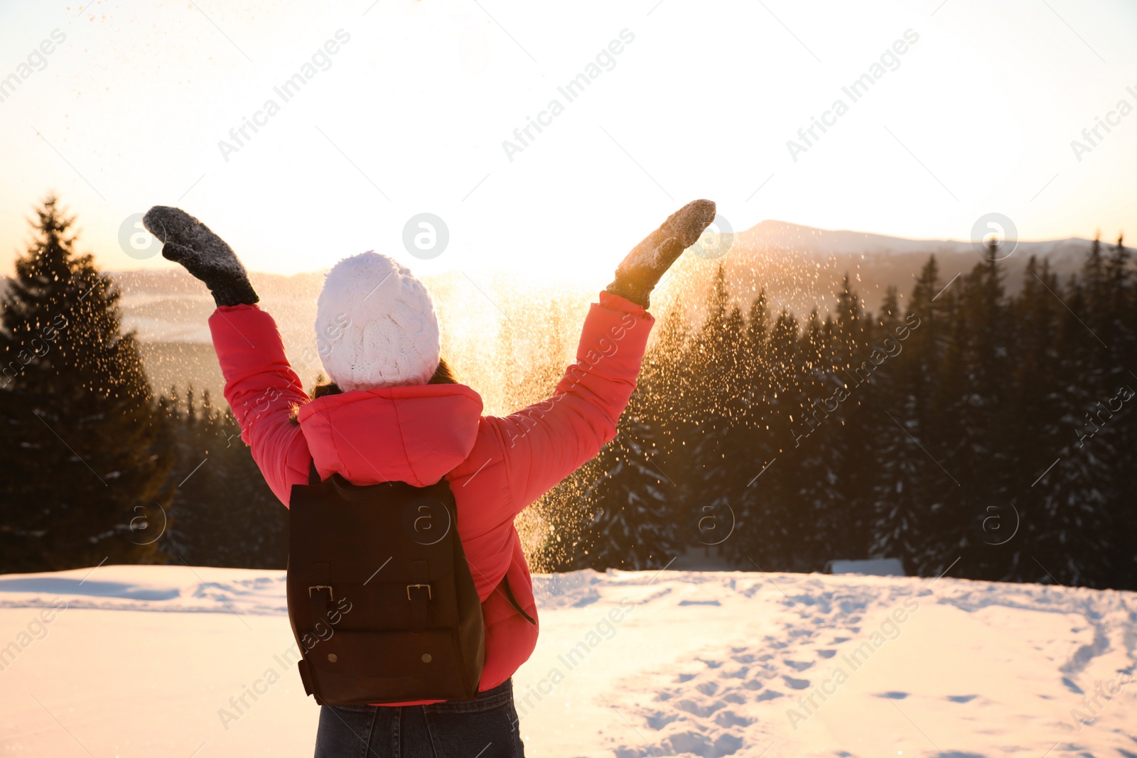 Photo of Young woman having fun outdoors on snowy winter day