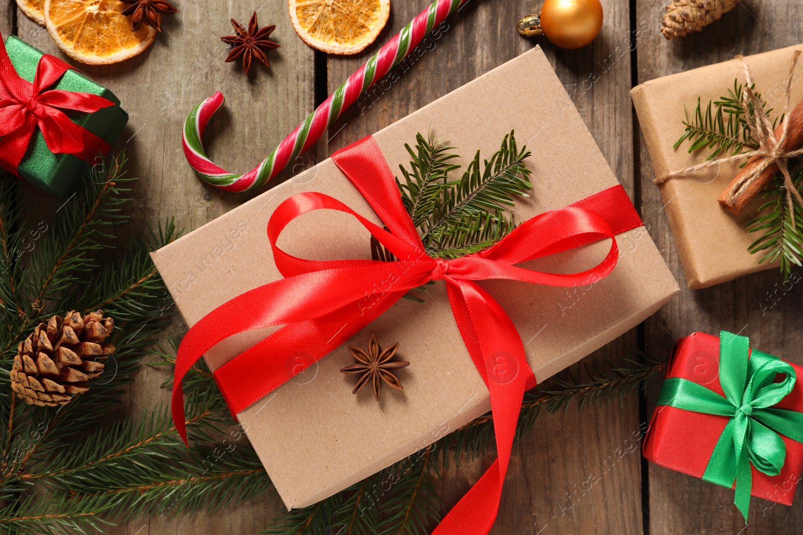 Photo of Flat lay composition with beautiful gift boxes and Christmas decorations on wooden table