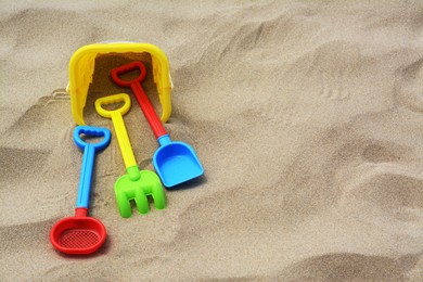 Set of colorful beach toys on sand. Space for text