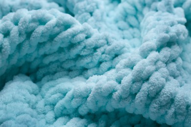 Photo of Soft light blue knitted fabric as background, closeup