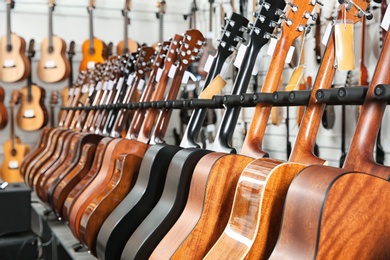 Photo of Row of different guitars in music store