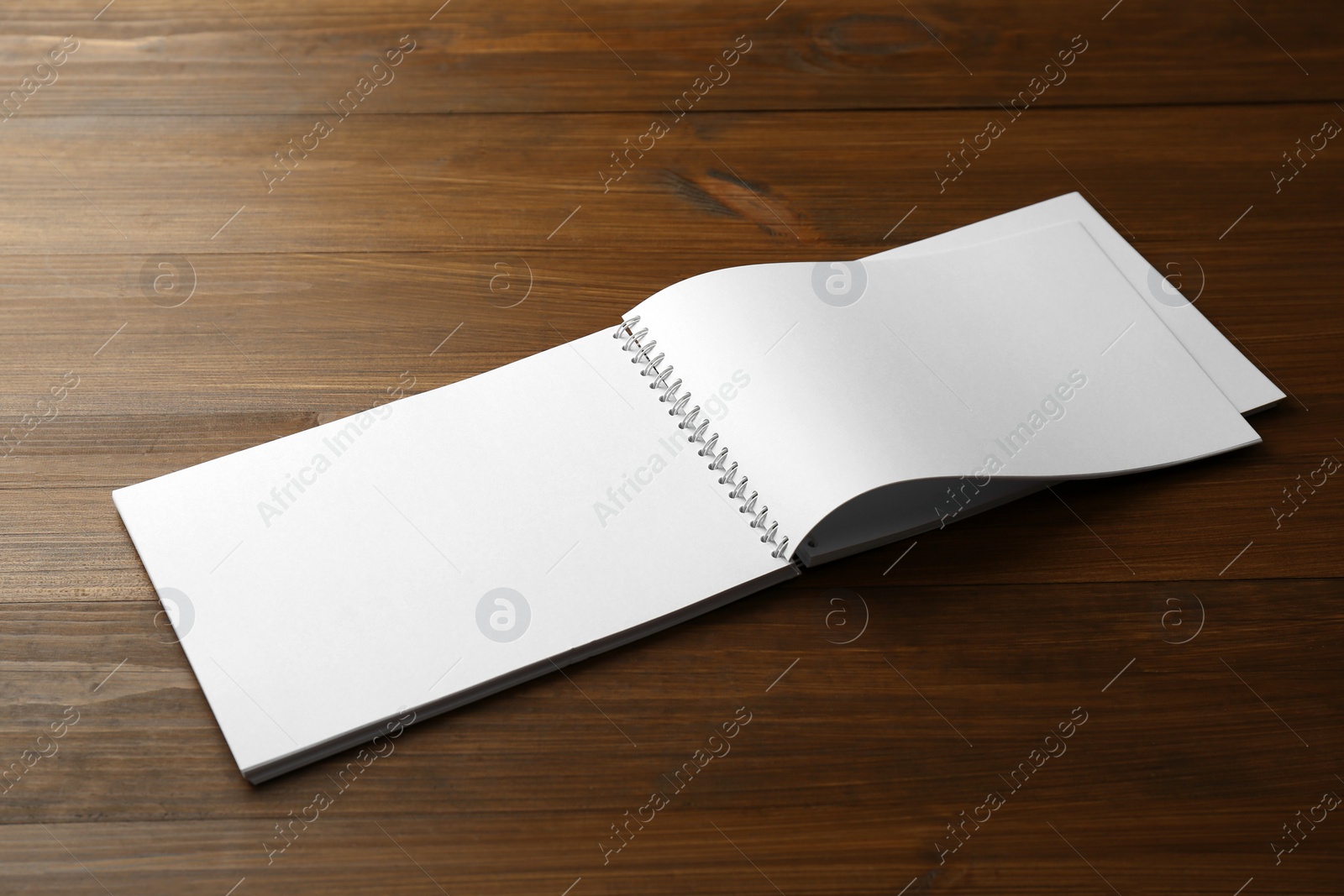 Photo of Blank paper brochure on wooden table. Mockup for design