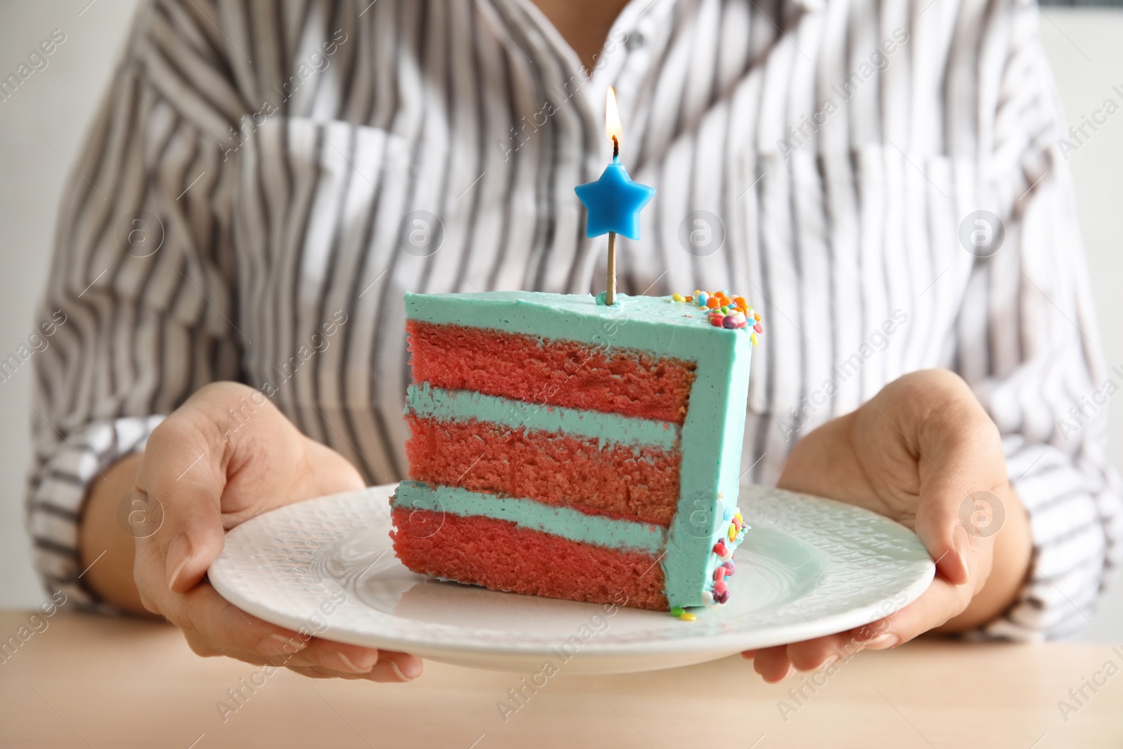 Photo of Woman holding fresh delicious birthday cake with candle, closeup