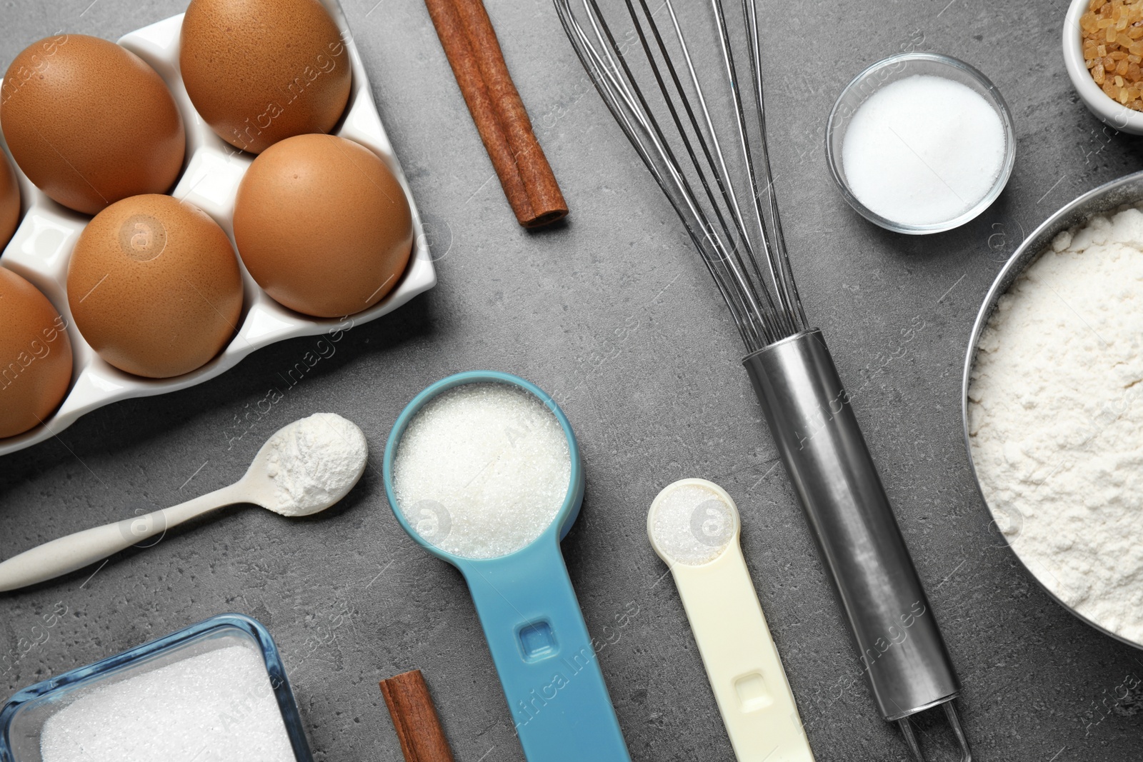 Photo of Flat lay composition with fresh ingredients for delicious homemade cake on grey table