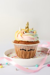 Photo of Cute sweet unicorn cupcake on white background