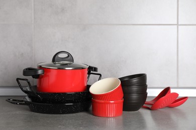 Photo of Set of different cooking utensils on grey countertop in kitchen