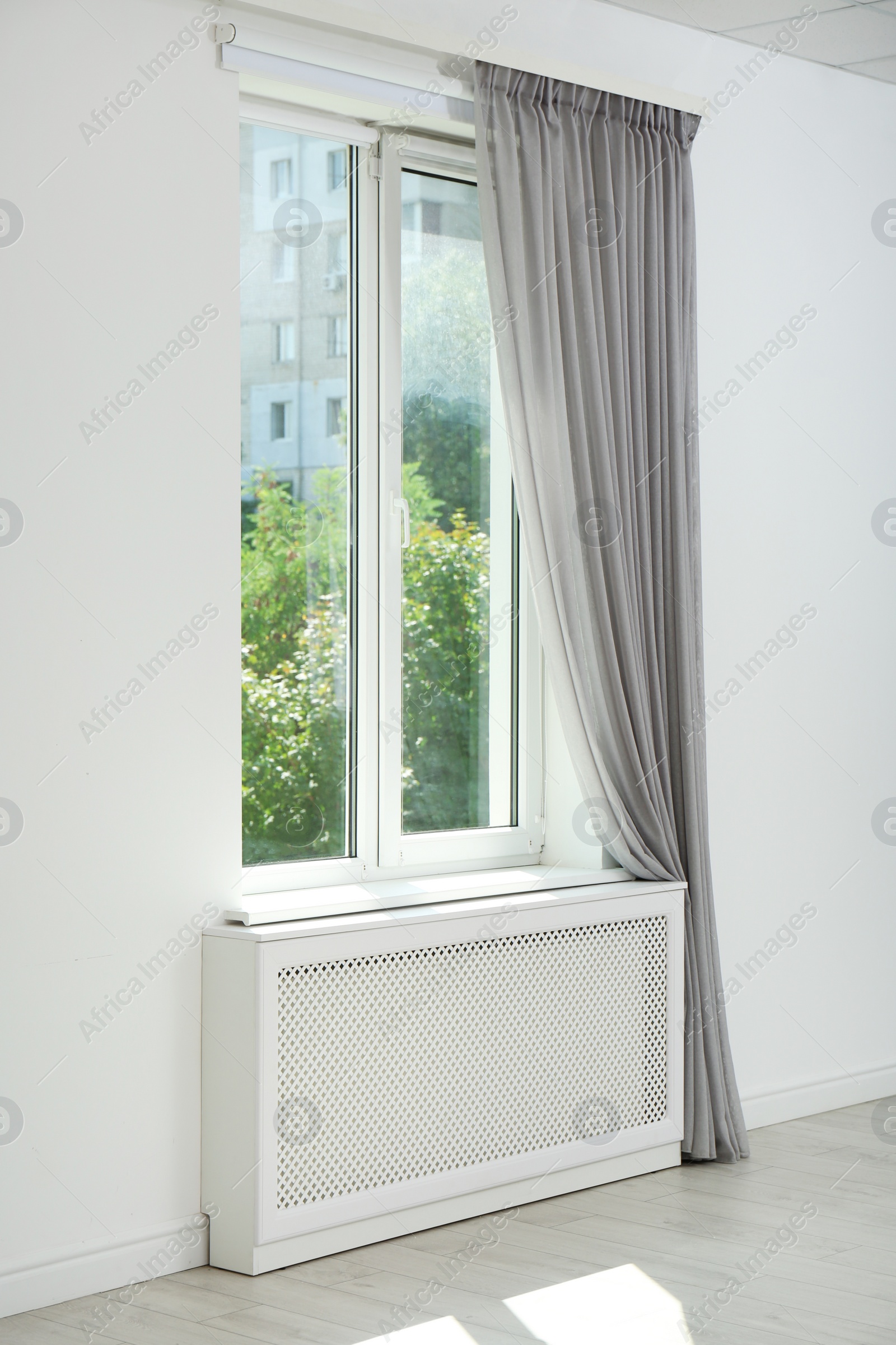 Photo of Light room with window and open curtains. Home interior