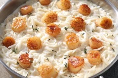 Delicious scallop pasta in pan, closeup view