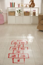 Photo of Red hopscotch floor sticker in room at home