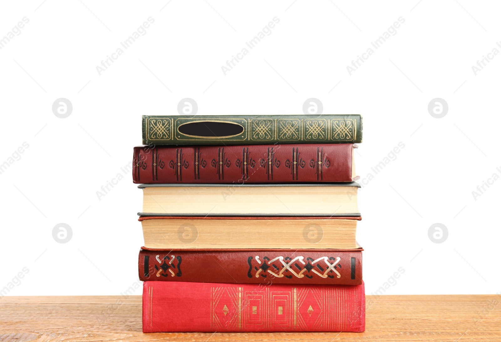 Photo of Stack of old vintage books on wooden table against white background