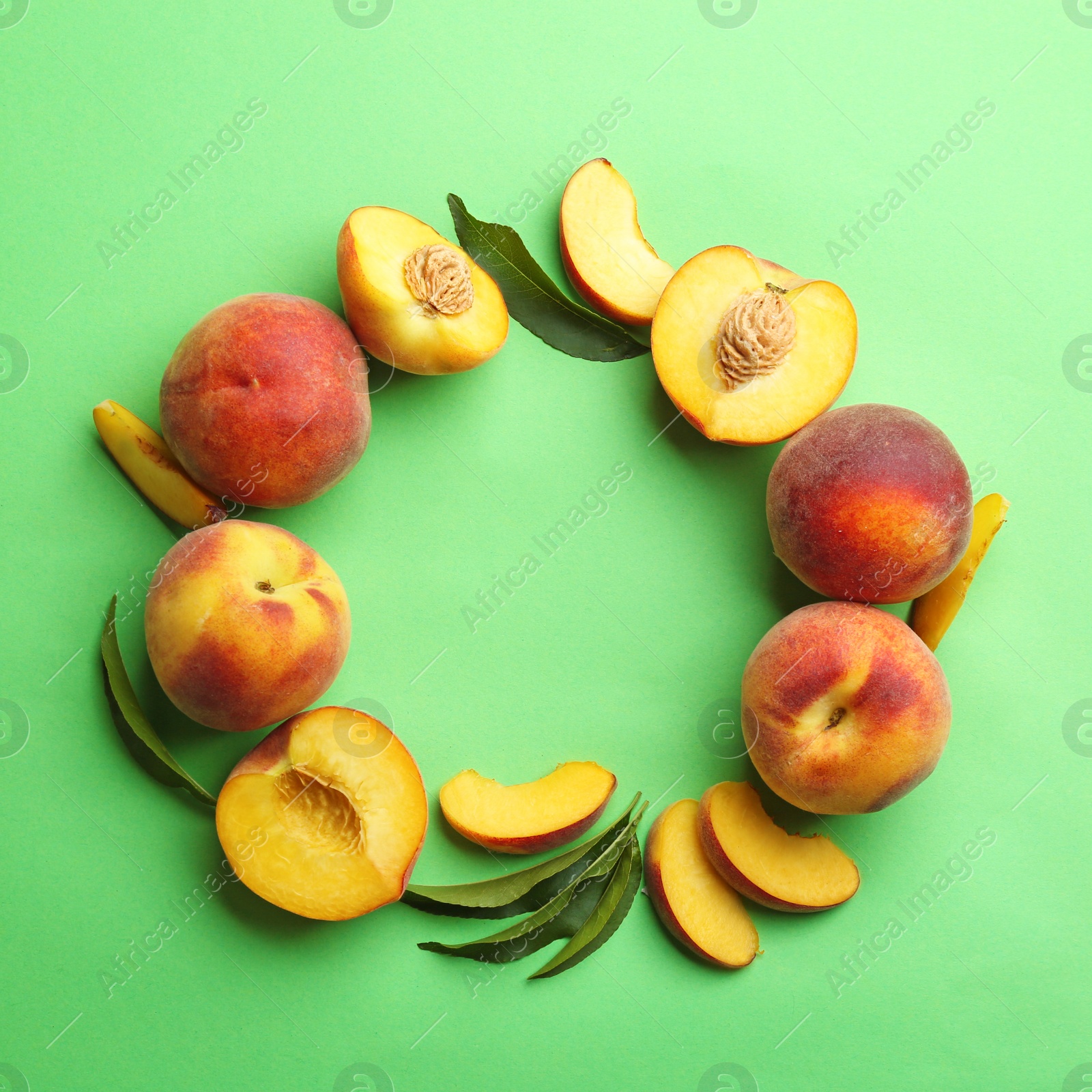 Photo of Flat lay composition with fresh peaches on green background. Space for text