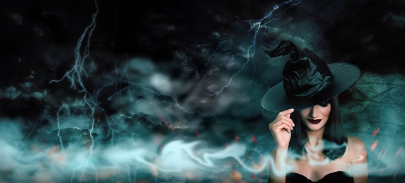 Image of Young girl dressed as witch in misty forest on stormy night. Halloween fantasy