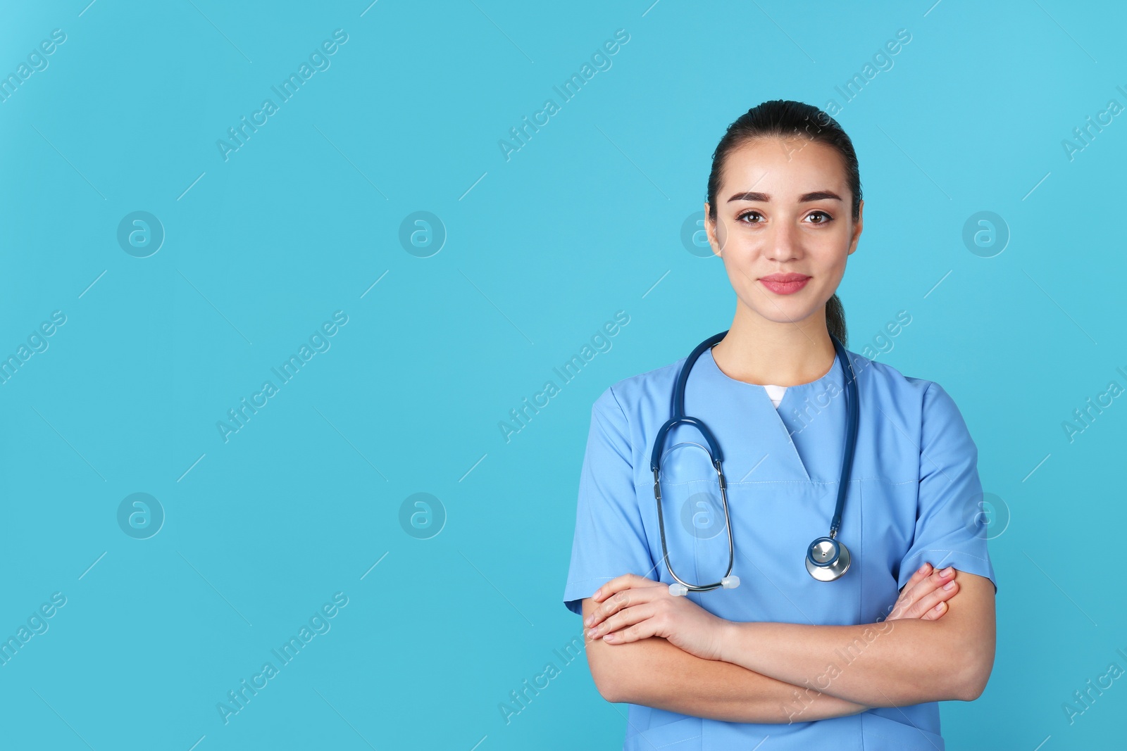 Photo of Young medical student in uniform on color background. Space for text