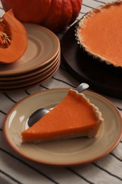 Photo of Plate with piece of fresh homemade pumpkin pie on table