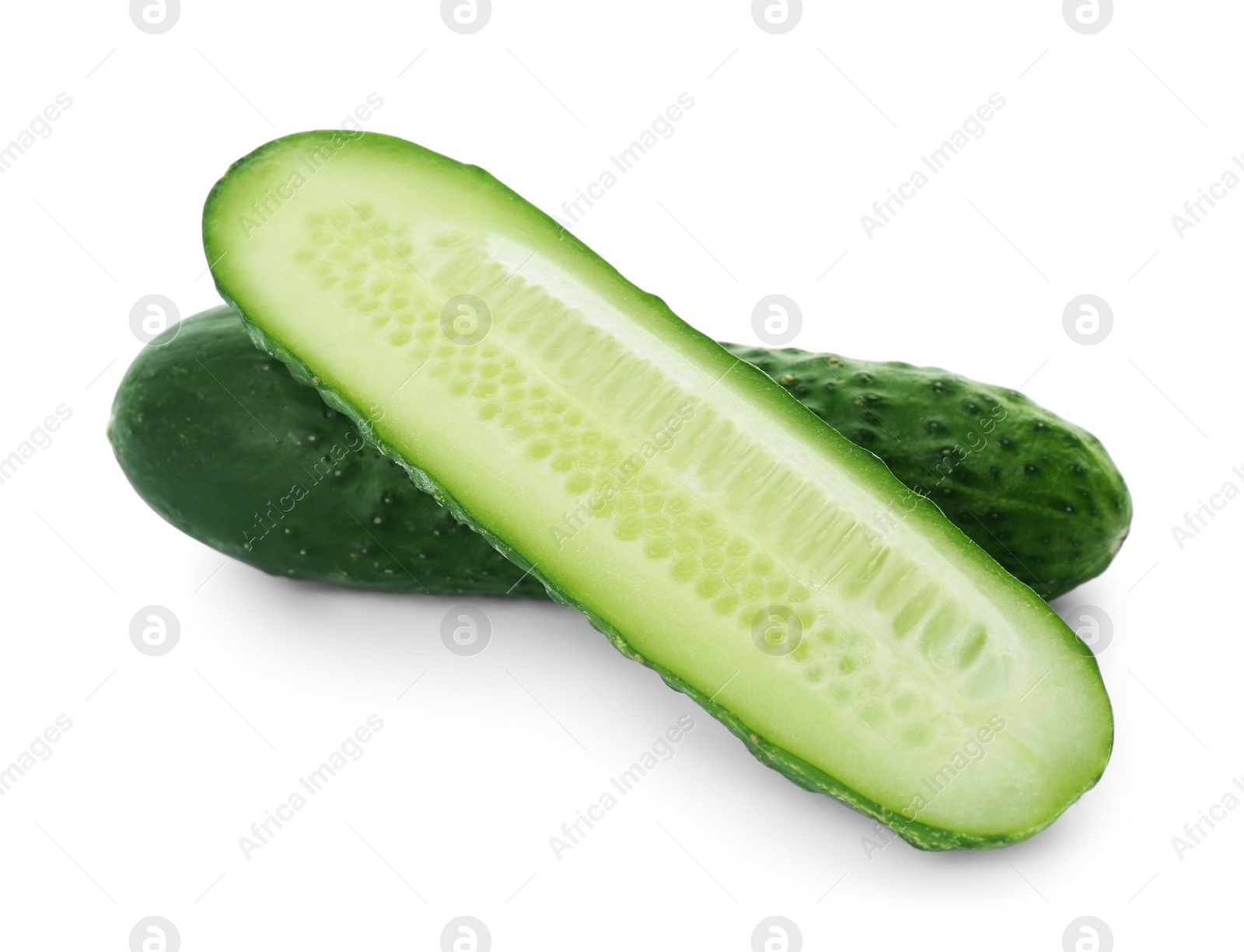 Photo of Whole and cut cucumbers on white background