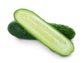 Photo of Whole and cut cucumbers on white background