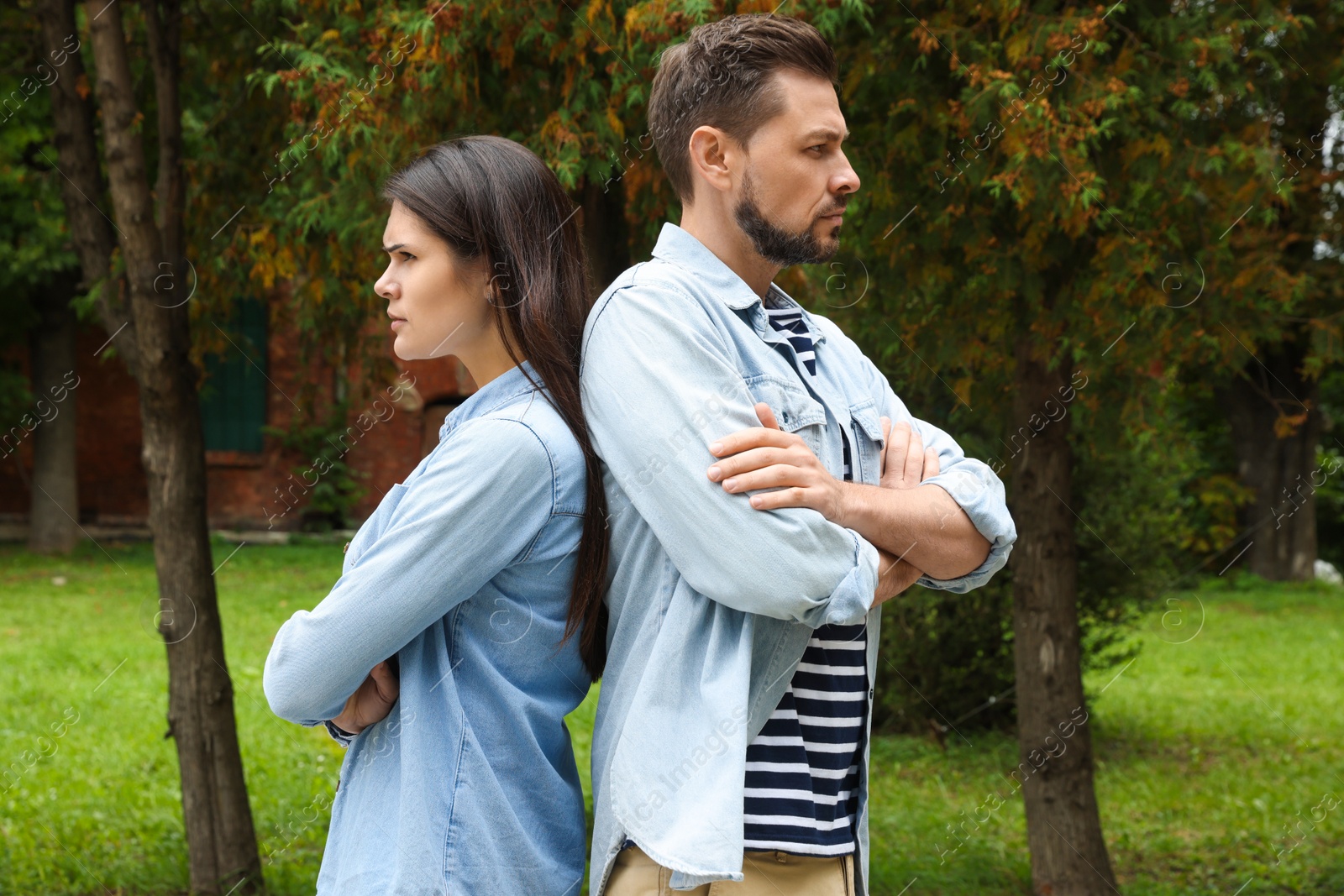 Photo of Upset arguing couple in park. Relationship problems