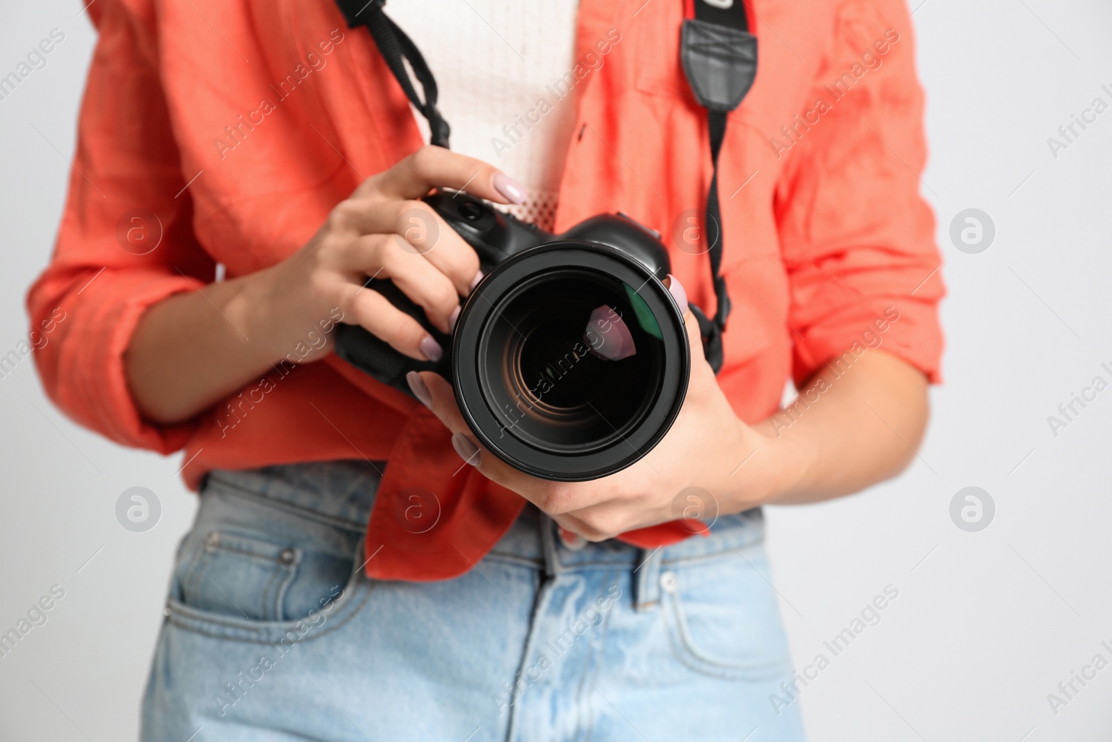 Photo of Professional photographer working on white background in studio, closeup