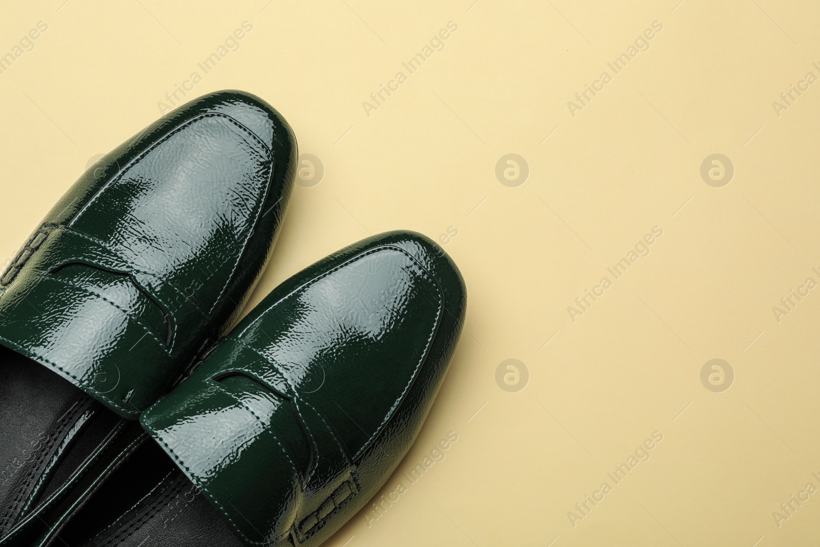 Photo of Pair of stylish female shoes on yellow background, top view. Space for text