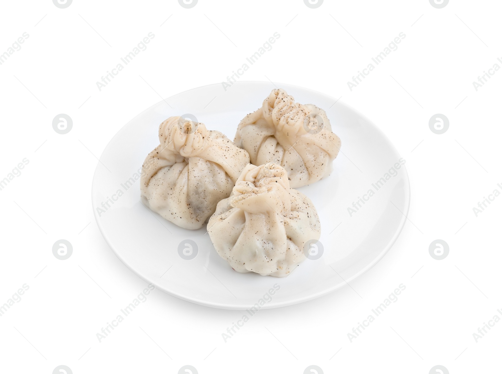 Photo of Plate with three tasty khinkali (dumplings) and spices isolated on white. Georgian cuisine