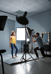 Beautiful model posing for professional photographer in studio