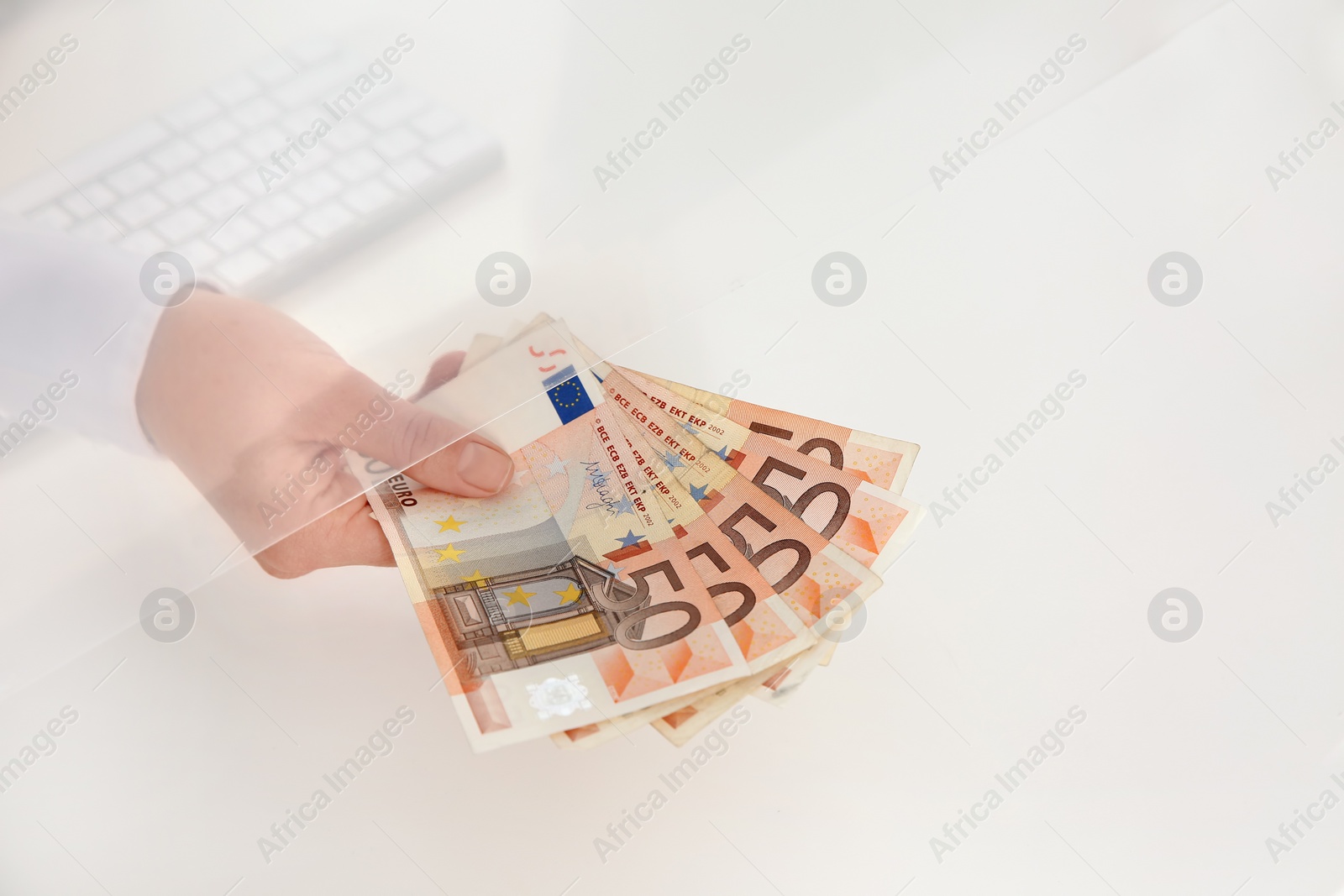 Photo of Teller with money at cash department window, closeup