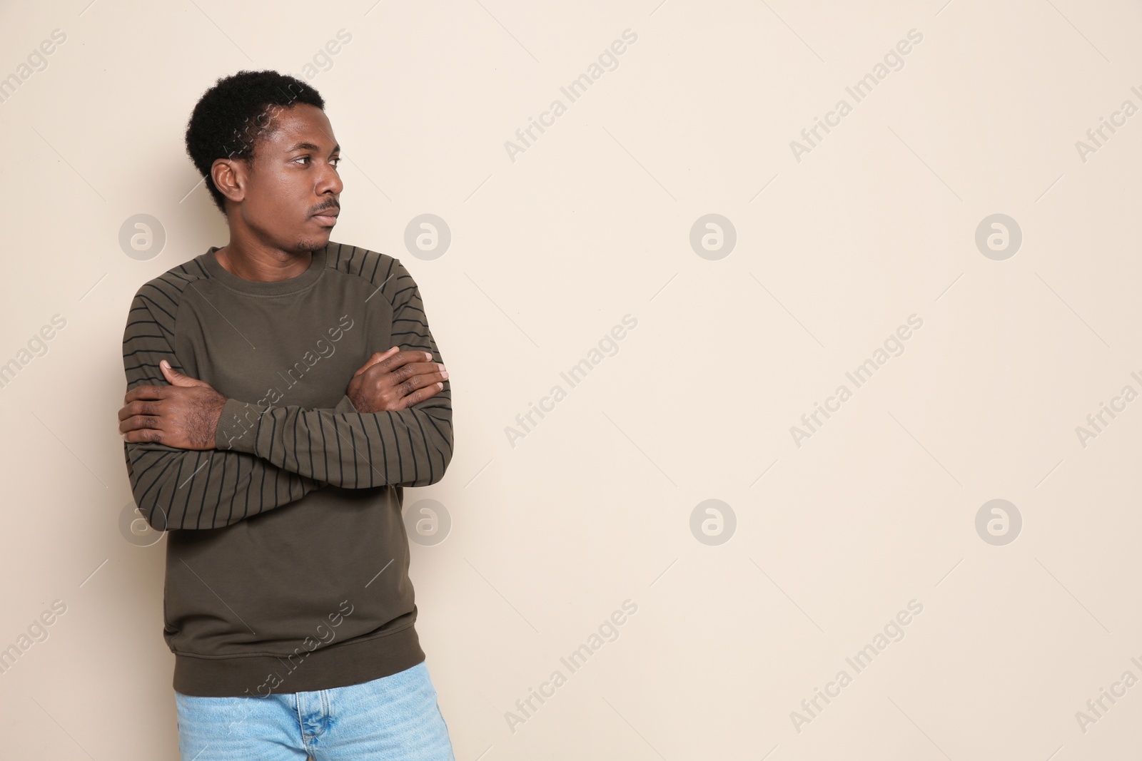 Photo of Portrait of African-American man on color background. Space for text