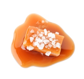 Photo of Delicious candy with caramel sauce and salt on white background