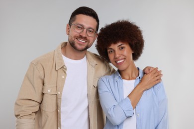 Photo of International dating. Portrait of lovely couple on light grey background