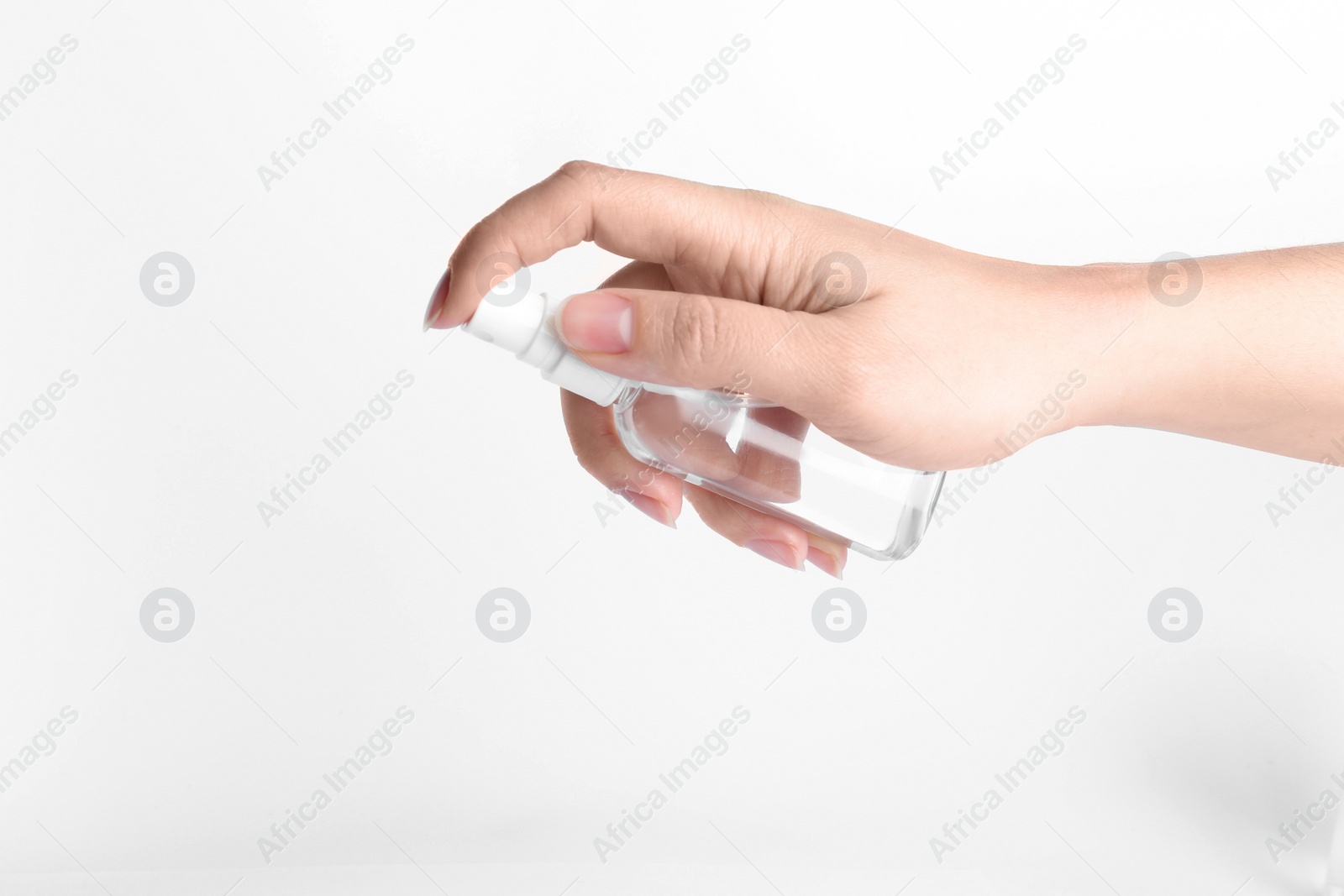 Photo of Woman holding antiseptic spray on white background, closeup