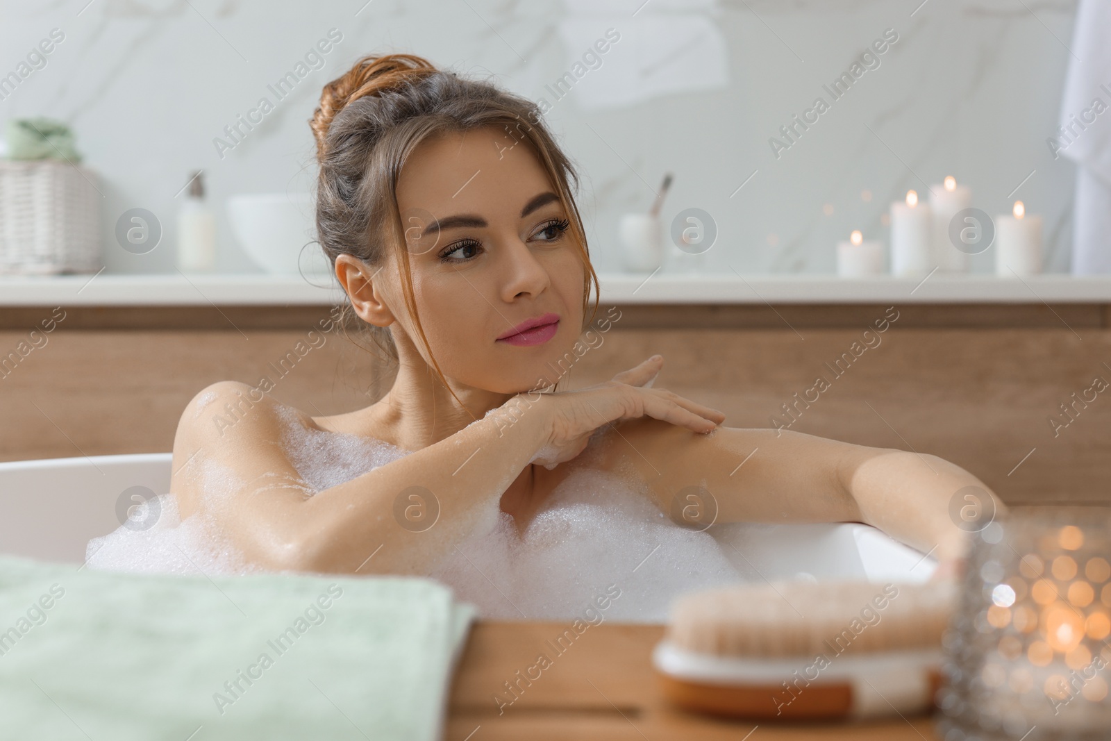 Photo of Beautiful woman enjoying bubble bath at home