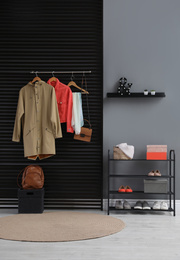 Hallway interior with stylish furniture, clothes and accessories