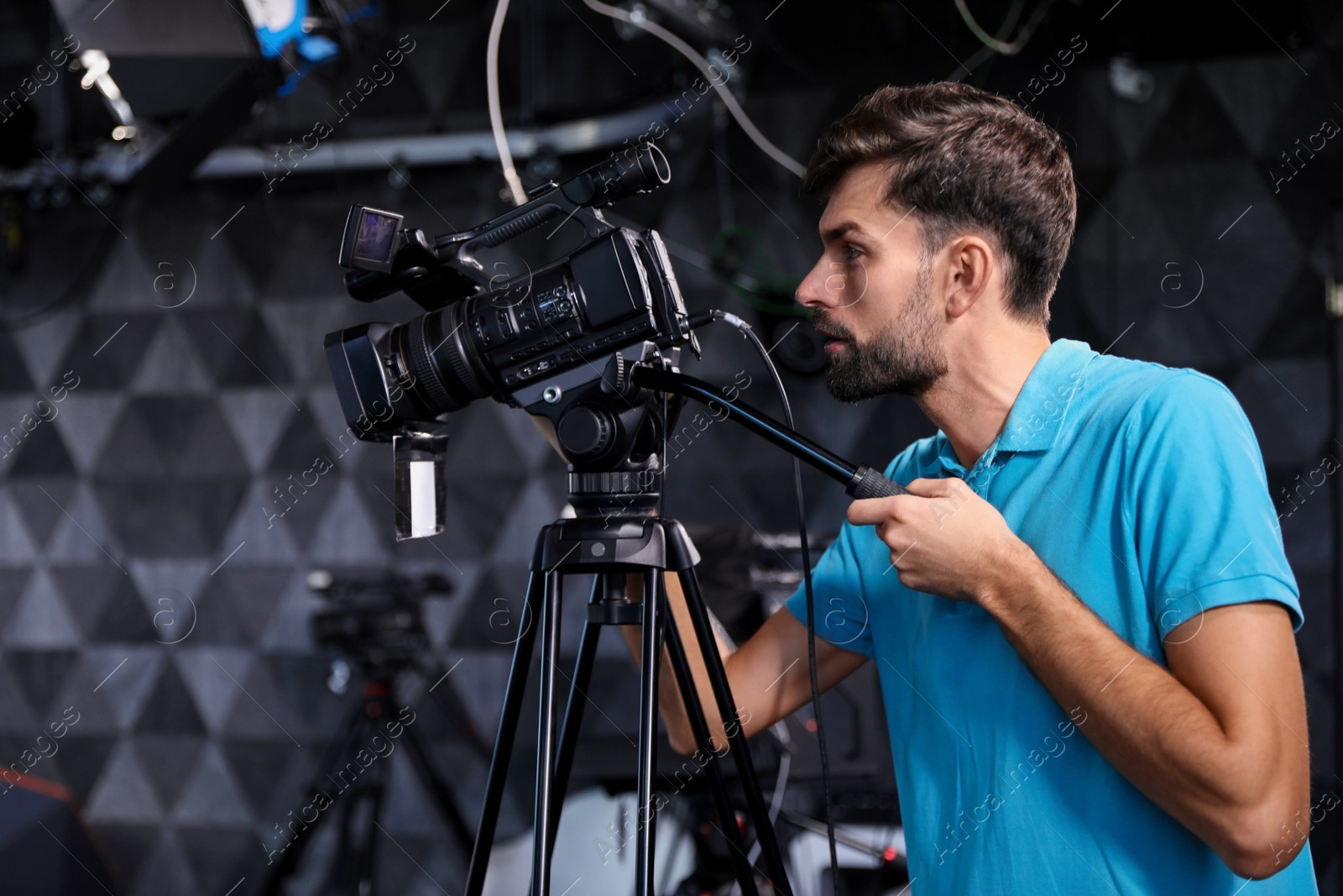 Photo of Professional video camera operator working in studio