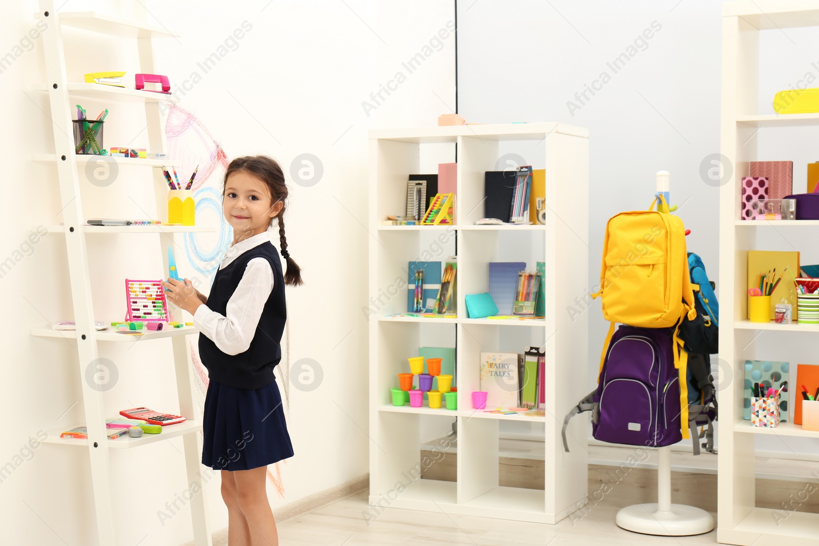 Photo of Cute child choosing school stationery in store